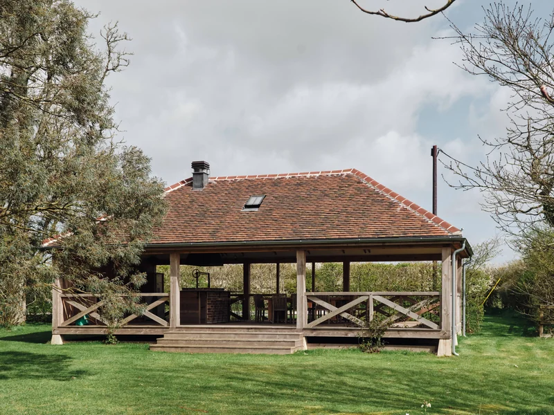 Open-sided timber entertaining pavilion with tiled roof