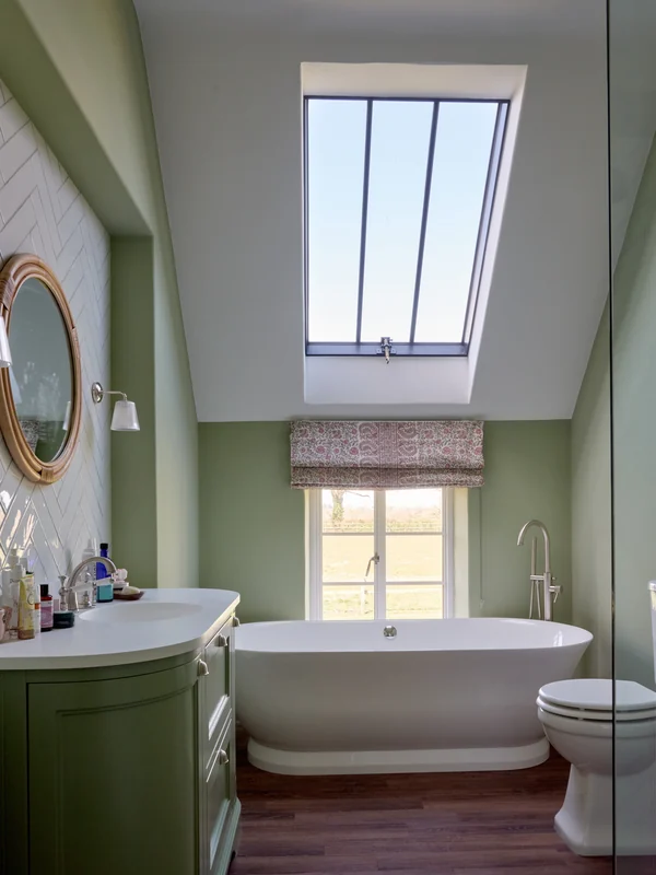 Bathroom with freestanding bath beneath a rooflight