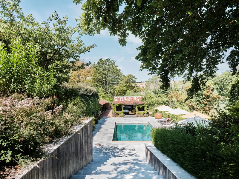 Garden steps descending towards the swimming pool and leisure buildings